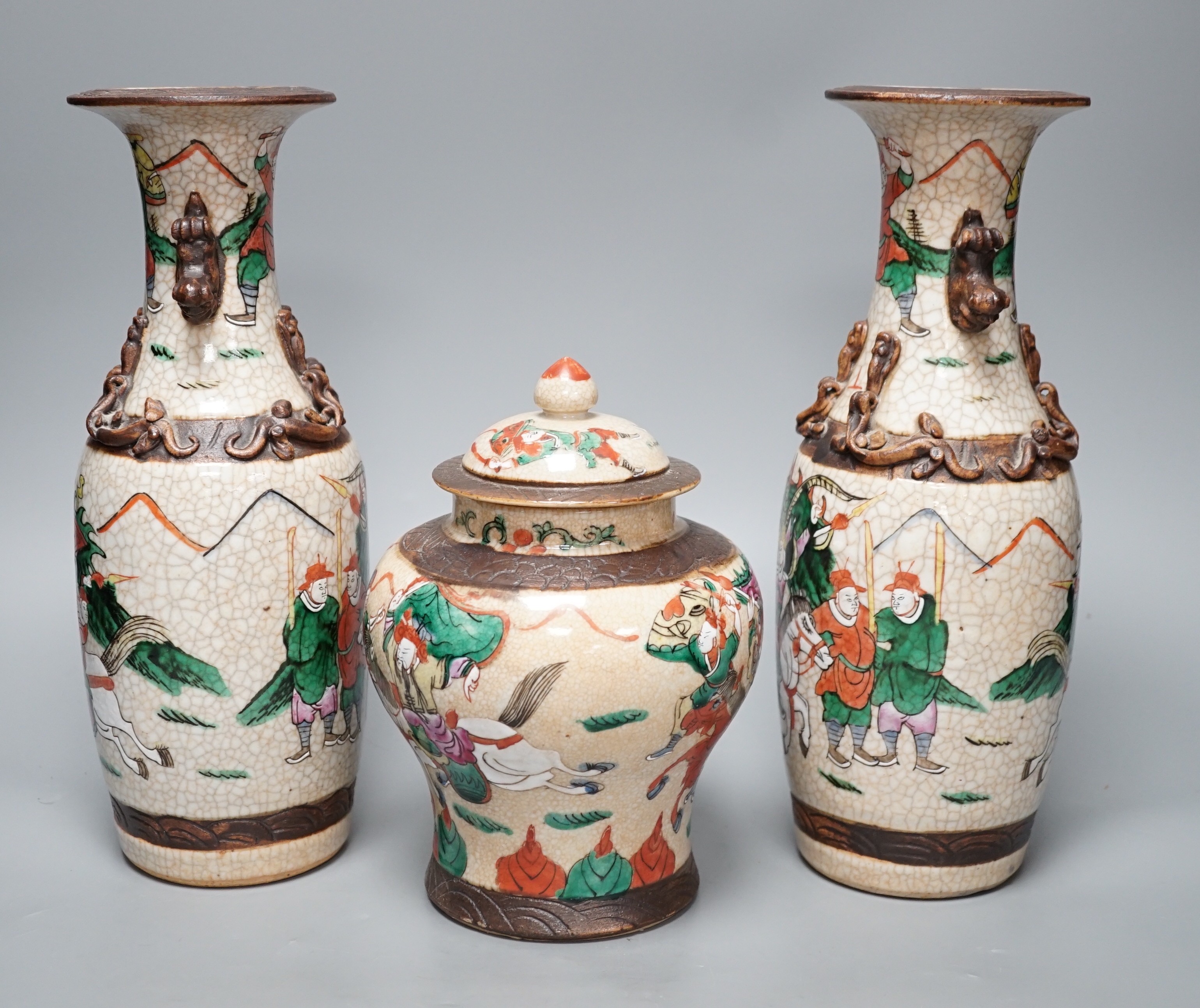 A pair of late 19th century Chinese crackle glaze vases and a similar vase and cover, tallest 29.5cm